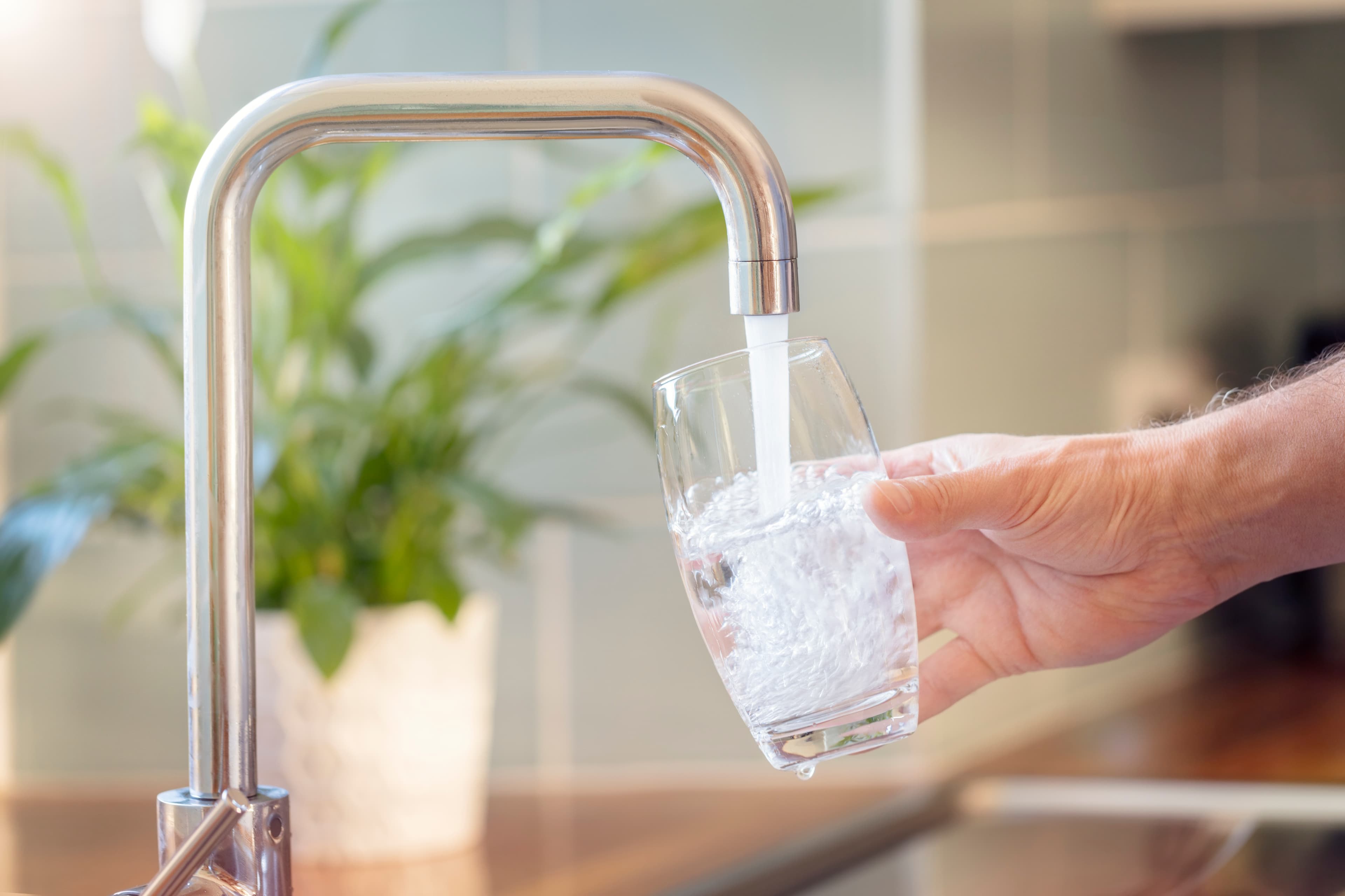 Reverse osmosis water flowing from a dedicated kitchen faucet
